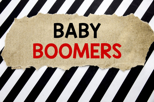 Handwritten text showing Baby Boomers. Business concept writing for Demographic Generation Written on note paper, black background with space.
