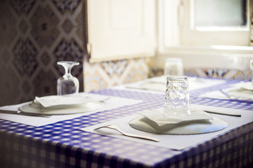 Table in traditional Portuguese restaurant ready for four people