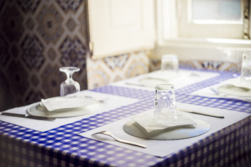 Table in traditional Portuguese restaurant ready for four people