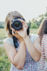 girl with camera on the field