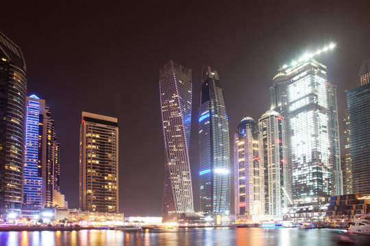DUBAI, UAE - FEBRUARY 2018: Colorful evening on canal and promenade in Dubai Marina,Dubai,United Arab Emirates