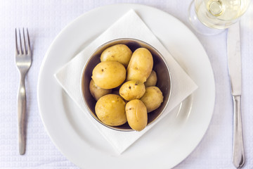 Cooked baby potatoes and white wine