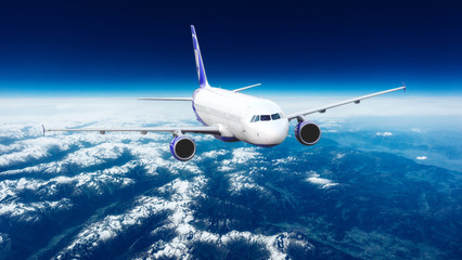 Fototapeta na wymiar Flying of a passenger plane over the land