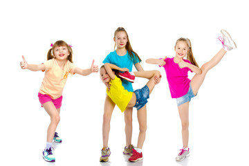 A group of girls gymnasts perform exercises.