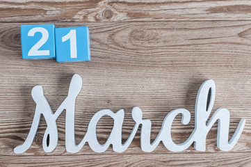 March 21st. Day 21 of march month, daily calendar on wooden table background with carved text. Spring time