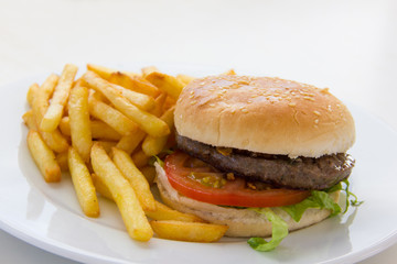 Delicious burger with french fries on isolated white background. Tasty beef hamburger with lettuce,...