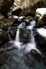 Fototapeta na wymiar Small waterfalls in the forest.