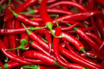 Red peppers background texture of hot red chili, seasoning paprika, fiery red hot in the kitchen a dish of red pepper for sale