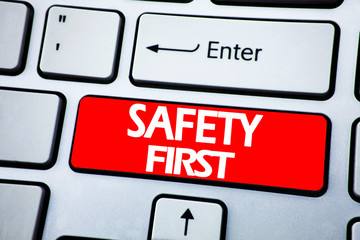 Handwriting Announcement text showing Safety First. Business concept for Safe Warning written on red key on the keybord background.