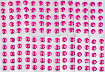 Full frame of round pink tablets pills in blister packs. Pink pills pattern use for love wallpaper. Ibuprofen tablets pills for relief pain, high fever, headache, toothache and wound inflammation