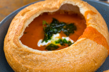 Tomato cream soup, soup puree served in round bread