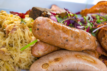 Meat sausages with vegetables and sauerkraut food background