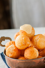 Small cottage cheese doughnuts (castgnole) served in a vintage bowl. Festive dessert.