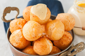 Small cottage cheese doughnuts (castgnole) served in a vintage bowl. Festive dessert.