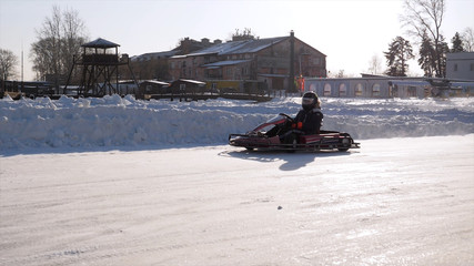 Winter carting on the snow track. Winter karting competition on the ice track. Winter carting. Racing karting in slow motion