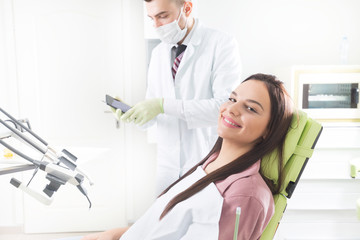 Happy female patient at the dental office