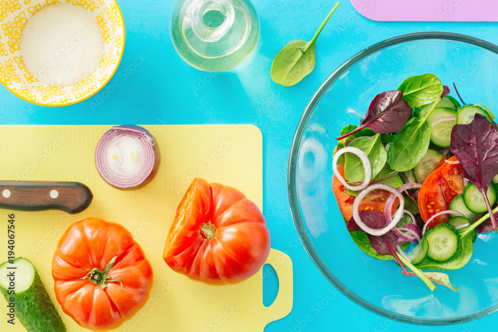 Canvas Prints Fresh ingredients for cooking summer salad on blue background, top view. Healthy food background