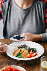 Healthy vegetarian food concept. Woman eating vegetarian food (black quinoa and cutlets from oatmeal and prunes)