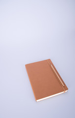 notebook or leather diary and pencil on the blackground.