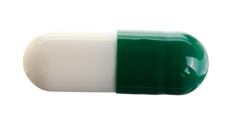 white pill capsule isolated on white background macro. Top view