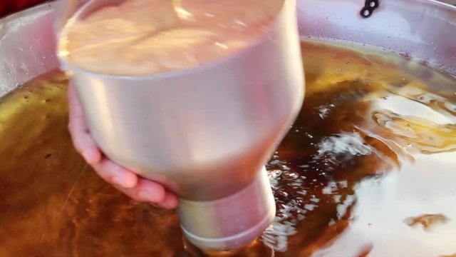 making donut boil on hot oil with bakery matchine