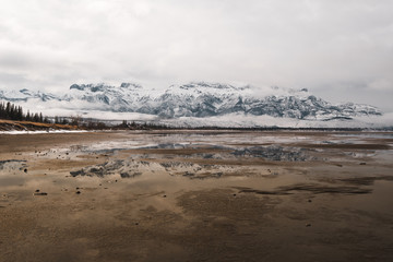 A distant mountain range against a flooded plain in the Canadian Rockies