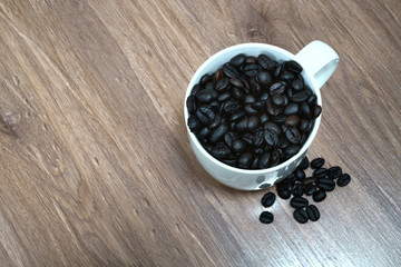 Coffee Bean in Cup on the Wooden floor  