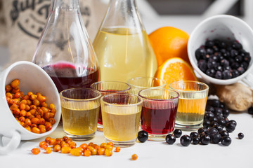 Currant wine in a bottle on wooden table. Sweet alcohol made from many varieties berry fruits
