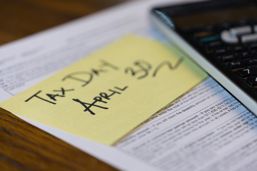 Tax Form with Sticky note with Deadline close up