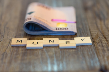 Nigerian Naira Bundle with Money spelled out in letter tiles