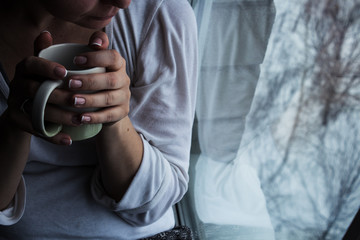 girl is sitting near the window