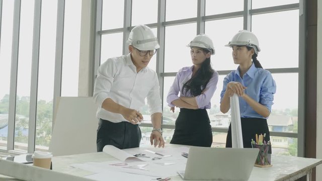 Team of architect and engineer brainstorming at a construction site.