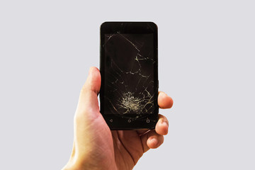 Cracked smartphone in hand holding.