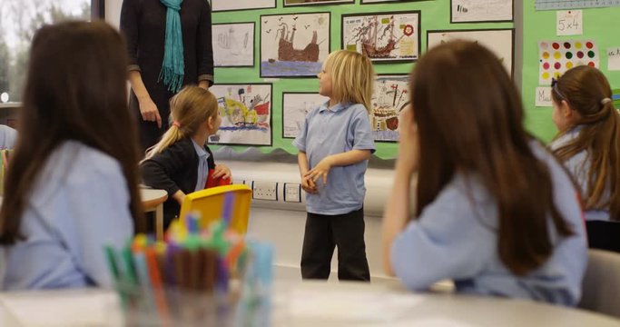 4K Cute little boy demonstrating dabbing trend in classroom & making his friends laugh. Slow motion