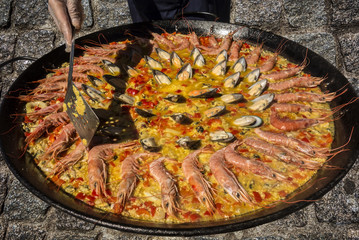 The process of cooking paella with seafood