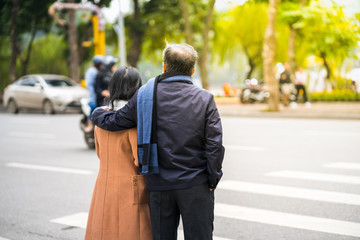 People walking across a street in Hanoi, Vietnam. Closeup