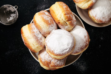 Sufganiyot donuts with jelly on black background