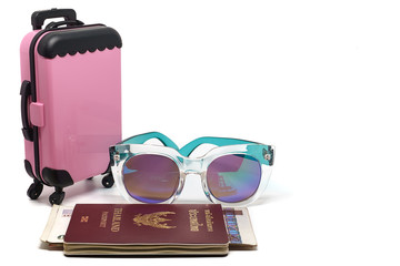 Pink luggage, Thai passport with banknotes and fashion sunglasses