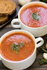 Thick Italian soup minestrone on a wooden table