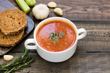 Thick Italian soup minestrone on a wooden table