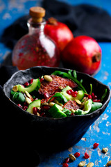 AUTUMN ARUGULA SALAD WITH CARAMELIZED SQUASH with  POMEGRANATE GINGER VINAIGRETTE