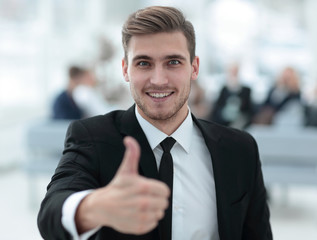 portrait of happy businessman showing thumb up.