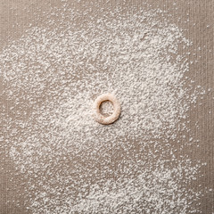 Letter O made of raw dough on flour