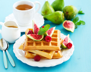 Homemade waffles with caramel sauce, figs and raspberries.