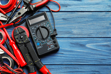 Different electrical tools on wooden background