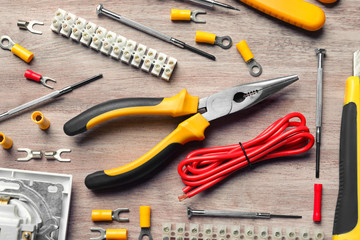 Different electrical tools on wooden background