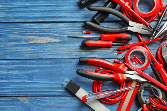 Different electrical tools on wooden background