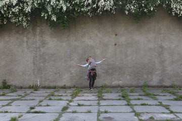 boy jumped mother against background gray wall