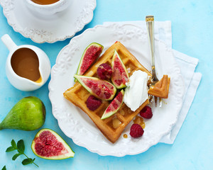 Homemade waffles with caramel sauce, figs and raspberries.