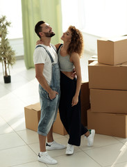 loving young couple standing in a new apartment